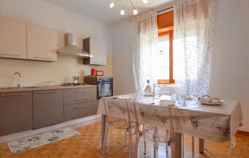 a kitchen with a table and chairs in a room at 2 Bedroom Lovely Apartment In Bosa in Bosa