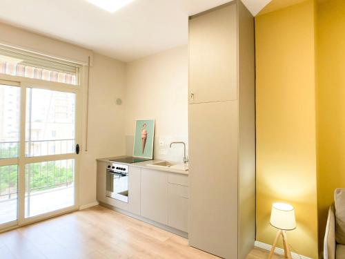 a kitchen with a sink and a window at PROMO Cozy Apartments in Golem
