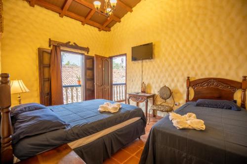 Postel nebo postele na pokoji v ubytování Hotel Caxa Real