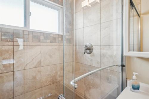 a bathroom with a shower with a glass door at 1 Bed Beach Condo #131 in Carpinteria