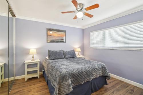 a bedroom with a bed and a ceiling fan at 1 Bed Beach Condo #131 in Carpinteria