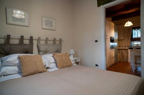 a bedroom with a large white bed with two pillows at colle del mondo country house in Collecorvino