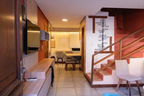 a room with a staircase and a table with chairs at Casa João e Maria - CANELA in Canela