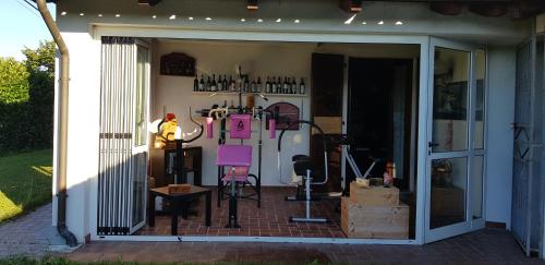 an open door of a garage with a refrigerator at Casa Caginia 300mqgiardinopalestra e biliardo in Tigliole
