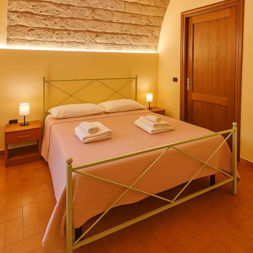Un dormitorio con una cama con dos toallas encima. en Il Vecchio Convento, en San Gimignano