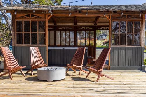 three lounge chairs and a fire pit on a wooden deck at Camp Trinidad RV Resort in Trinidad