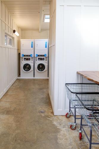 a laundry room with two washes and a cart in it at Camp Trinidad RV Resort in Trinidad