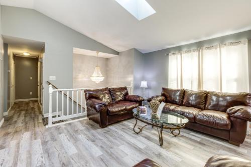 a living room with leather couches and a table at Walk to Beach Elegant Escape in Lusby! in Lusby