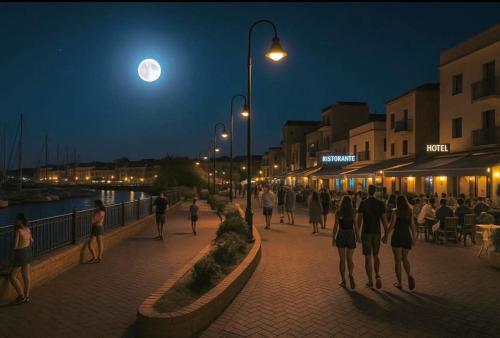 a group of people walking down a street at night at Casa al mare Portoscuso in Portoscuso