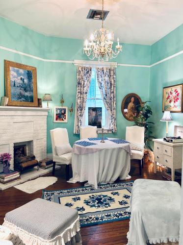 a blue room with a bed and a fireplace at DOLLHOUSE, 6 BR, French Quarter, JAZZ FEST sleeps 13! in New Orleans