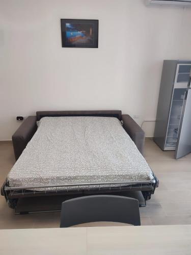 a bed in a room with a picture on the wall at Casa al mare Portoscuso in Portoscuso