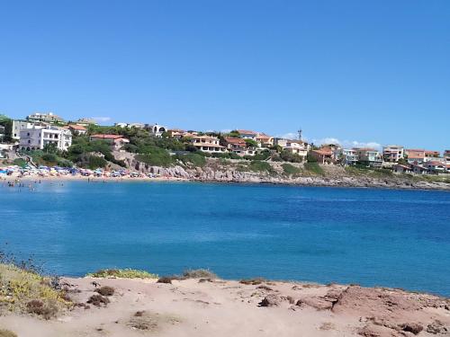 a view of a beach with buildings in the background at Casa al mare Portoscuso in Portoscuso
