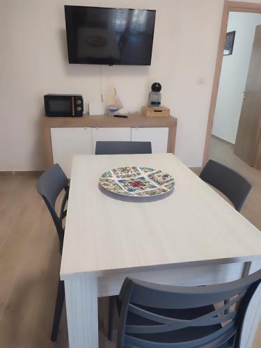 a pizza sitting on top of a table with chairs at Casa al mare Portoscuso in Portoscuso
