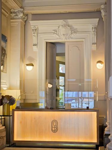 a counter in a room with a mirror at Hôtel L'orque Bleue in Sète