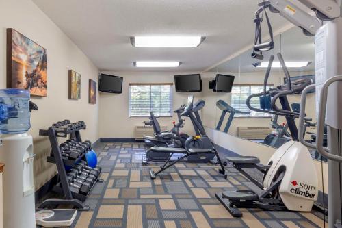 a gym with treadmills and ellipticals in a room at Best Western Plus Berkshire Hills Inn & Suites in Pittsfield