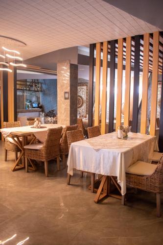 a dining room with two tables and chairs at Mantra Hotel Boutique in Santa Marta