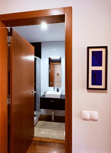 a bathroom with a sink and a mirror at Gelfa SEAcrets in Caminha