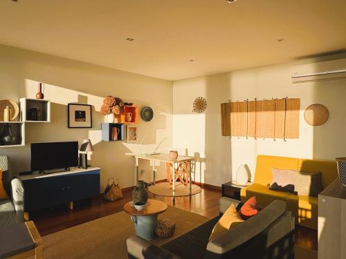 a living room with a couch and a table at Gelfa SEAcrets in Caminha