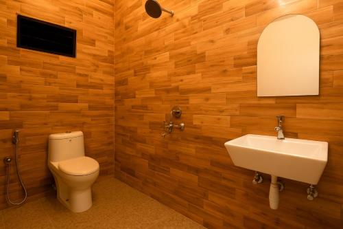 a bathroom with a toilet and a sink at Calangute Beach Home Away in Calangute