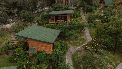 a model of a small house with a green roof at EcoHotel Cantos del Rio in Cajamarca