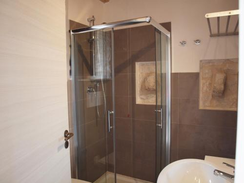 a shower with a glass door in a bathroom at Agriturismo Arà in Casale Zappulla