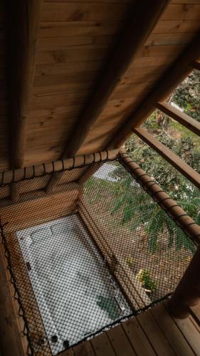 a bird cage inside of a wooden roof at EcoHotel Cantos del Rio in Cajamarca