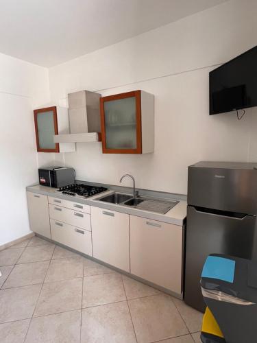 a kitchen with a sink and a stove top oven at La Marinella in Palmi