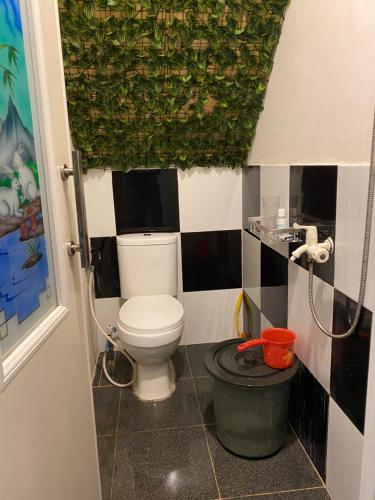a small bathroom with a toilet and a shower at Kabin Sahara in Pulau Tidung-kecil
