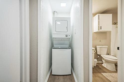 a small bathroom with a refrigerator and a toilet at The Chandler 1111 I Comfy 2 Bed 2 Bath in Grand Prairie