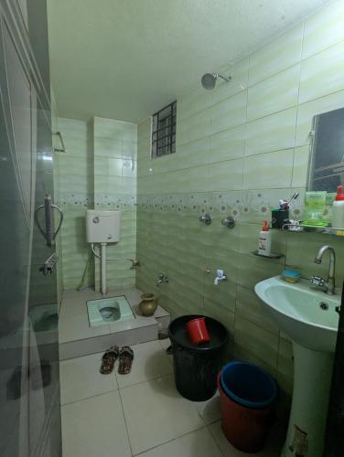 a small bathroom with a sink and a toilet at Revert in Dhaka
