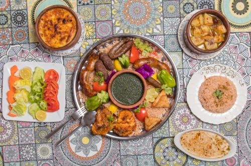 a table with a plate of food on a table at Nubian Kulih house in Aswan