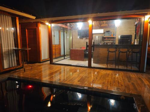 a dance floor with a large glass window in a room at La Playa Bangalô in Arraial d'Ajuda