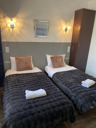 two beds sitting next to each other in a room at Hotel Clair Logis in Argelès-sur-Mer