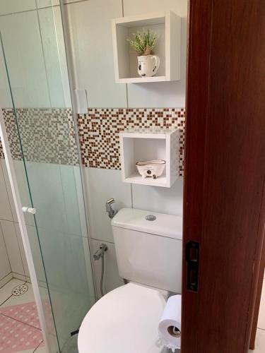 a bathroom with a toilet and a glass shower at flat 013 - Serra Negra - Bezerros - PE in Bezerros