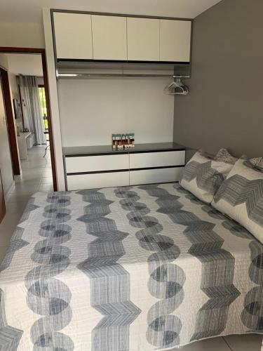 a bedroom with a large bed and a dresser at flat 013 - Serra Negra - Bezerros - PE in Bezerros