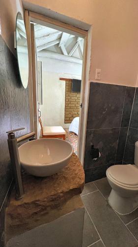 a bathroom with a sink and a toilet at Hotel Casa Amalia in Villa de Leyva