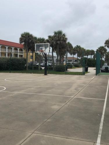 an empty basketball court with a basketball hoop at Ocean Alley in New Smyrna Beach