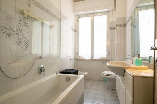 a bathroom with a tub and a toilet and a sink at La Casa del Sole-Viareggio in Viareggio