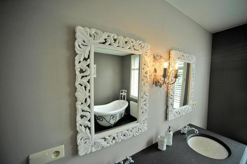 a bathroom with a sink and a mirror on the wall at Guesthouse Expo 13 in Ghent