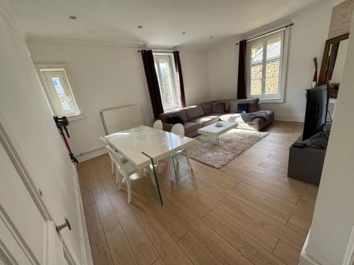 a living room with a table and a couch at Appartement 3 chambres 6 personnes in Sedan