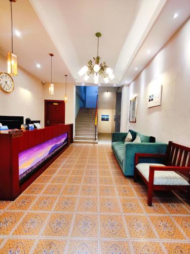 a living room with a couch and a table at Dzongkar - MG Marg - 3 Star Hotel in Gangtok