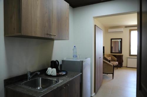 a kitchen with a sink and a refrigerator at LaForge Resort 
