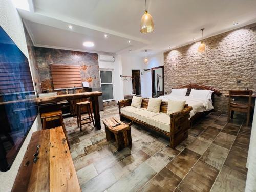 a living room with a bed and a table at City Retreat Studio X in Arusha