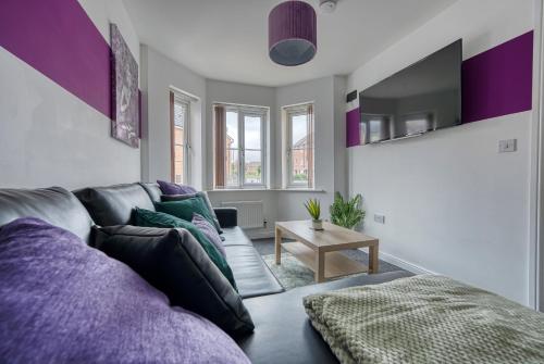 a living room with a couch and a table at Fantastic CONTRACTOR ACCOMMODATION - 5 Bedrooms and driveway! in Coventry