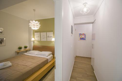 a bedroom with a bed and a hallway at Bianca Suites in Nea Moudania