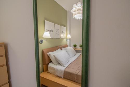 a mirror reflection of a bed in a bedroom at Bianca Suites in Nea Moudania