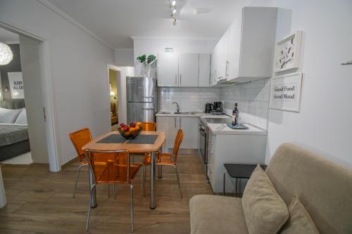 a kitchen and dining room with a table and chairs at Bianca Suites in Nea Moudania