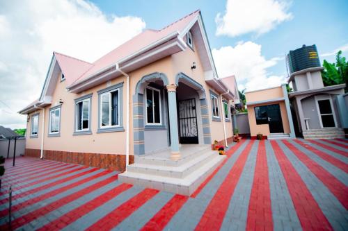 a house with a red carpet in front of it at Private Nest Apartment 2 in Arusha