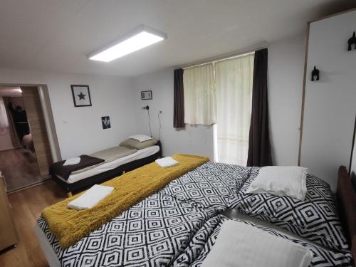 a hotel room with two beds and a window at Sweety-Apartman in Mátészalka