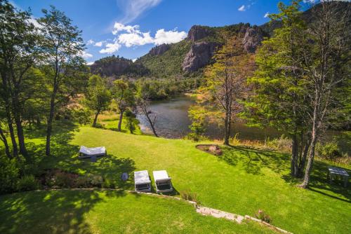an aerial view of a park with a river and mountains at Rio Hermoso Hotel De Montaña in San Martín de los Andes